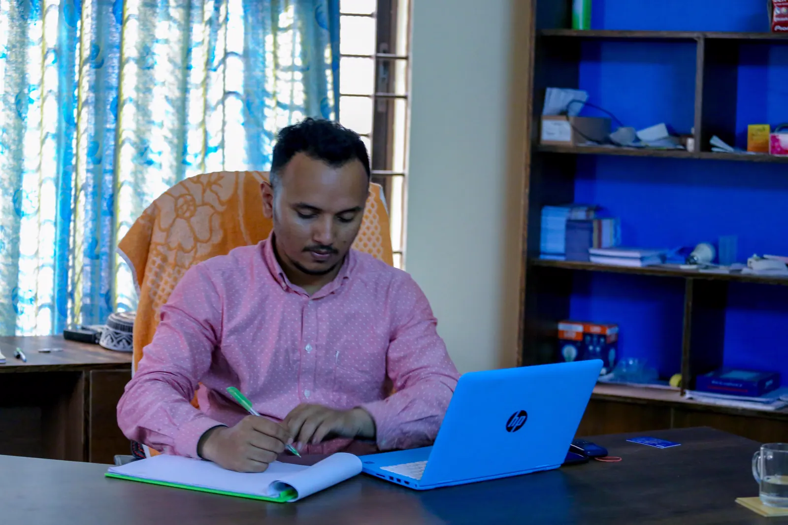 A FILP organiser working at a desk in the centre office