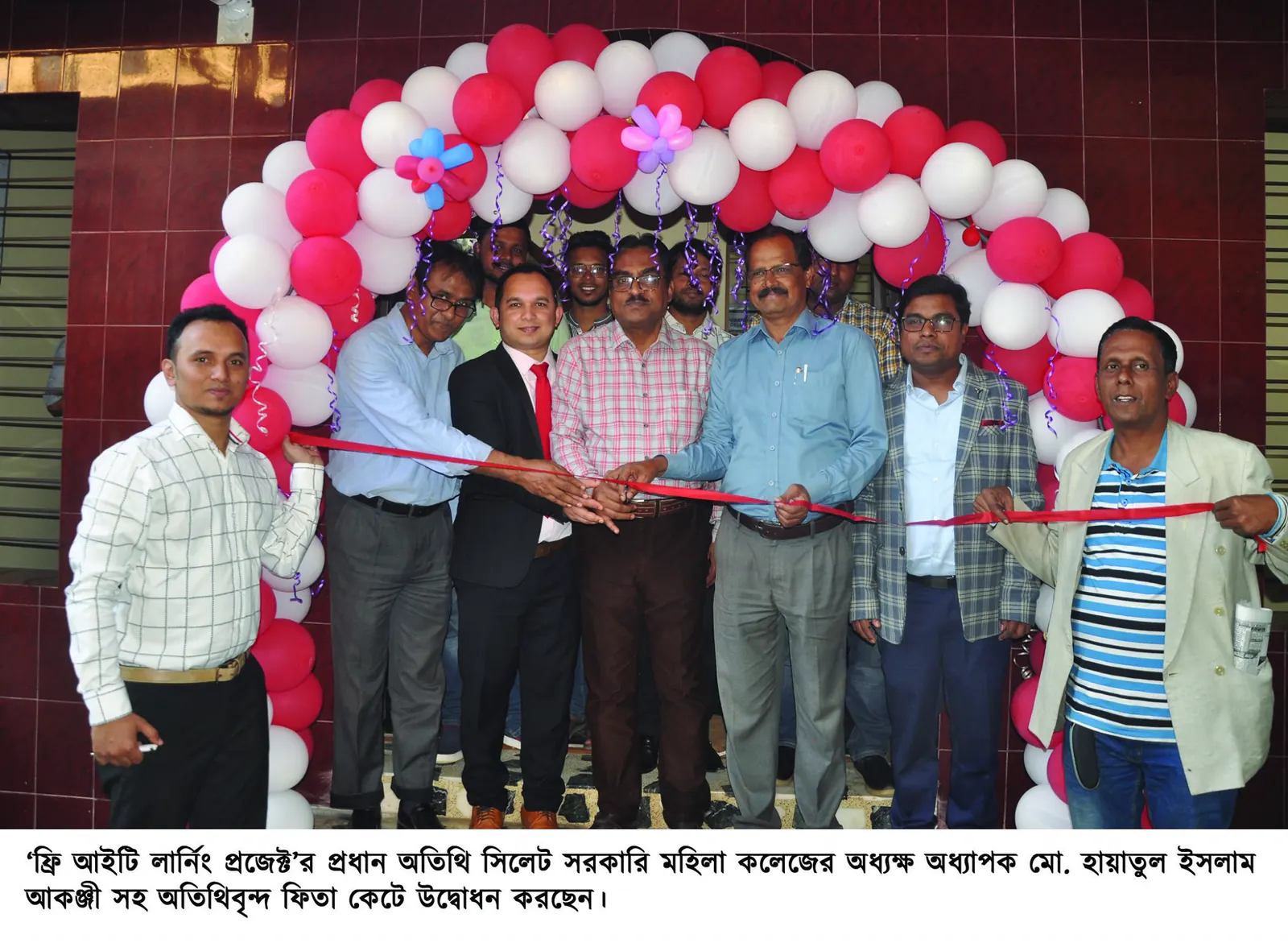 Guests cutting the ribbon under a balloon arch at the opening of the FILP centre