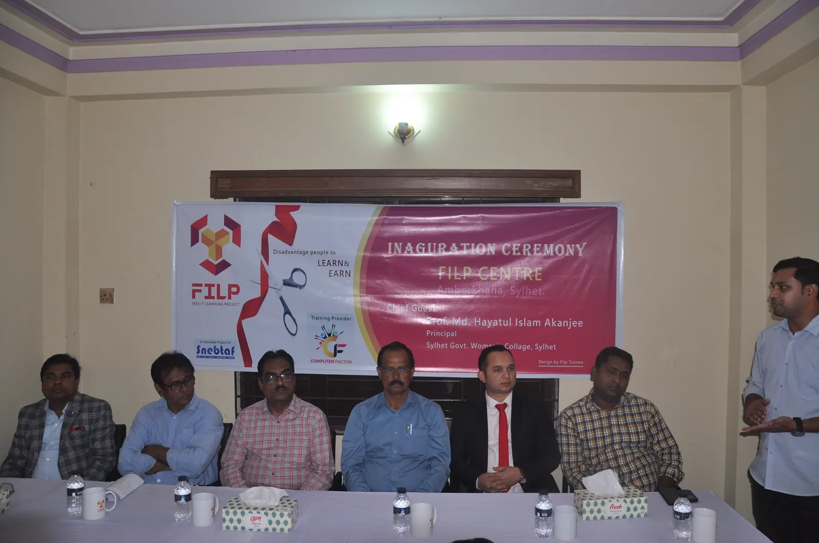 Guests seated beneath the inauguration banner at the FILP centre