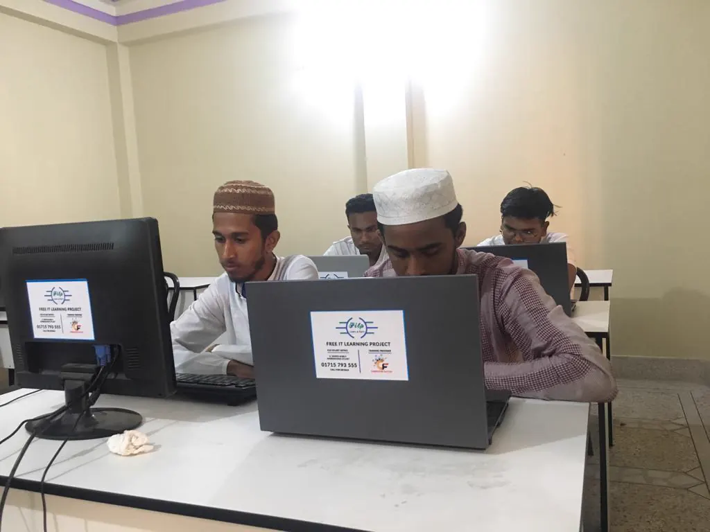 Students working together at a laptop