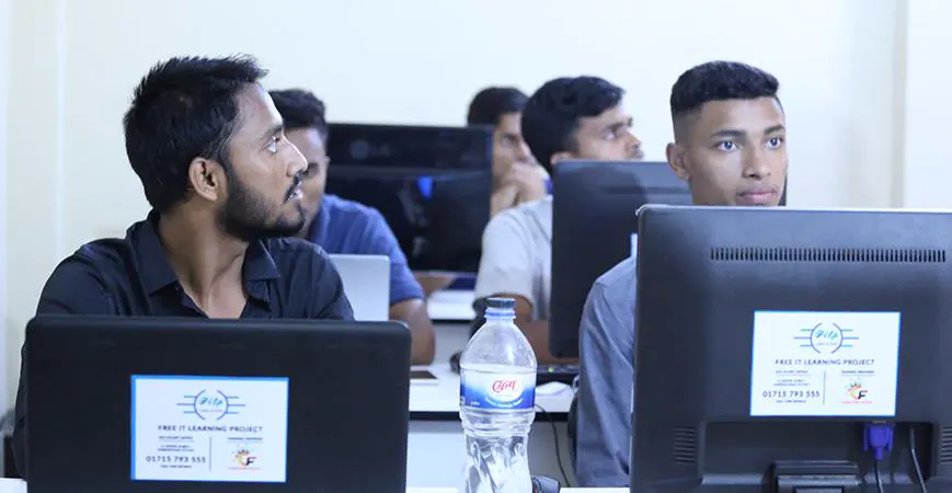 Students at their monitors in the training room