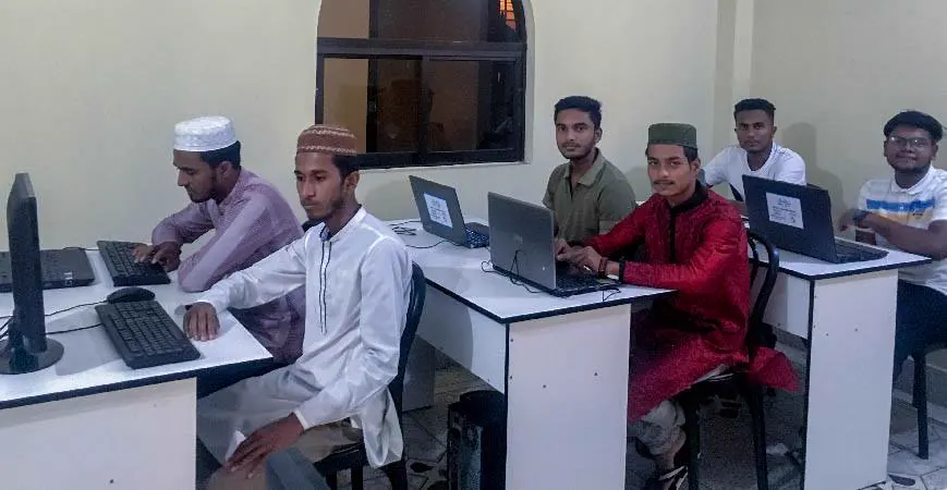 Students at laptops in the training room